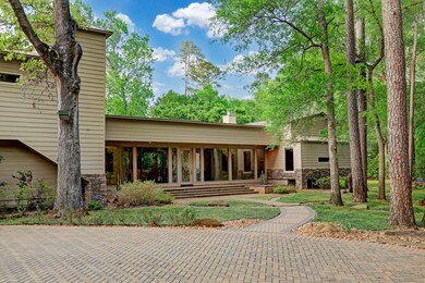 Walking trails with gorgeous gardens, storage shed, bubbling water fountains, endless outdoor patios, & a screen covered pool make this home feel like a resort.