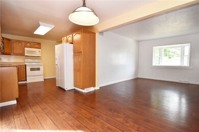 Corner view of kitchen, dining & living space