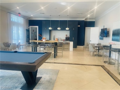 Game room with billiards table, ornamental molding, and recessed lighting