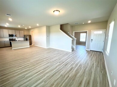 Unfurnished living room with baseboards, light wo