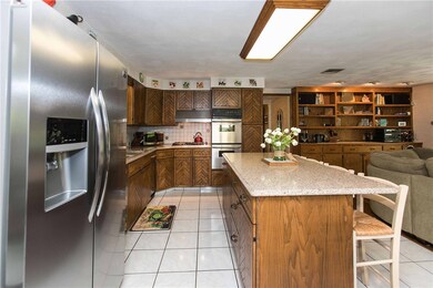 Large eat-in kitchen with center island, open to f