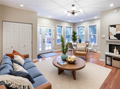 You will more than likely coming in the back door.  Great smaller gathering area again loaded with natural light courtesy of many windows.  The real hard wood floors continue into this room.  You are going to LOVE it.  Virtually staged.