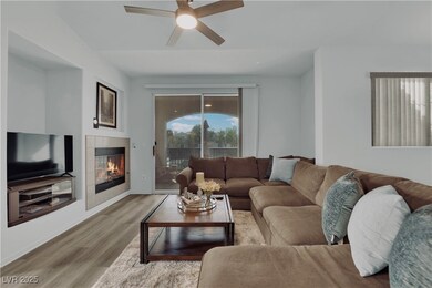 Living area featuring wood finished floors, a fire