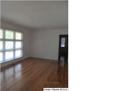 Livingroom with beautifully refinished hardwoods.