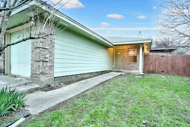 View of exterior entry with an attached garage
