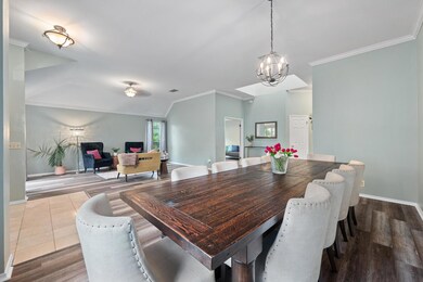 Dining space with a chandelier, crown molding, an