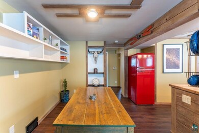 Kitchen with dark hardwood / wood-style flooring, 