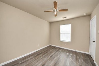 Bedroom #1- This downstairs bedroom serves perfectly as a guest room, complete with a half bathroom and attractive vinyl flooring.