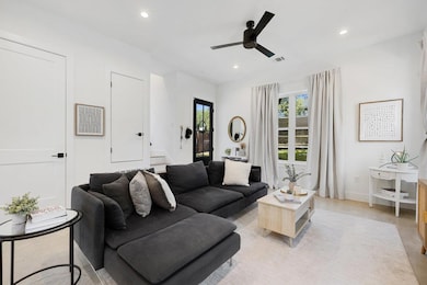 Living room featuring recessed lighting and a ceiling fan