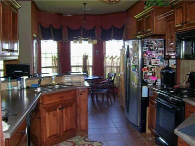 Kitchen. Lots of cabinets plus a pantry. Gas range and large dining area.