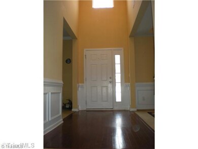 Entry. A welcoming two story foyer with beautiful glass chandelier and hardwood floor~ notice the detailed wood moldings!