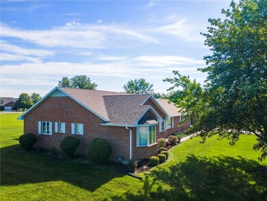 View of home's exterior featuring brick siding, a lawn, and roof with shingles