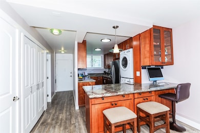 Reconfigured kitchen features rich cherry wood cabinets and sparkling granite counters with ample workspace for an avid baker and SO MUCH STORAGE!