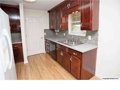 Fantastic kitchen with beautiful cabinets and laminate flooring.