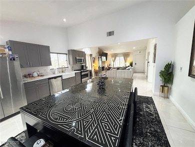 Kitchen featuring light countertops, high vaulted