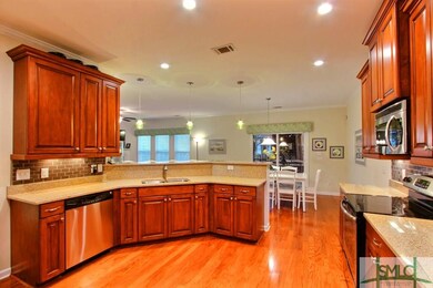 Wood floors continue from the entrance through the