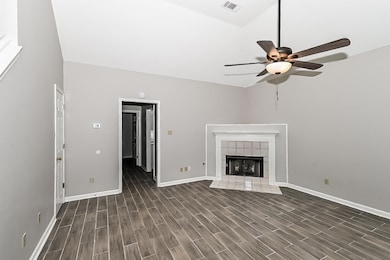Unfurnished living room featuring ceiling fan, vis