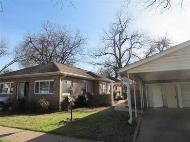 View of side of home featuring a lawn, brick sidin