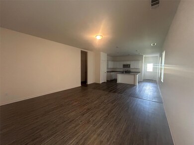 Unfurnished living room with sink and dark hardwood / wood-style floors