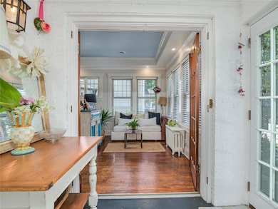 Looking from the sun room, you see the living room which the current owner, cleverly divided into two gathering spaces.