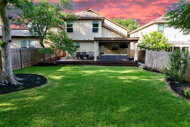 Back of property at dusk with an outdoor living s