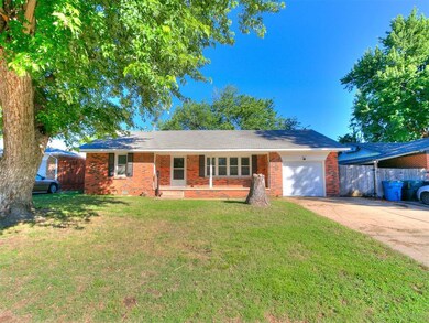 Single story home with an attached garage, concrete driveway, and brick siding