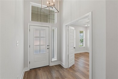 Entryway featuring wood finished floors, a chandel