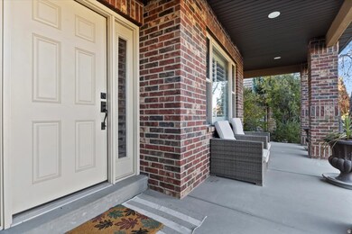Doorway to property with brick siding and a porch