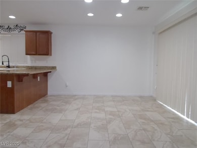 Kitchen with brown cabinets, recessed lighting, li