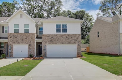 View of front of home with a front yard and a gara