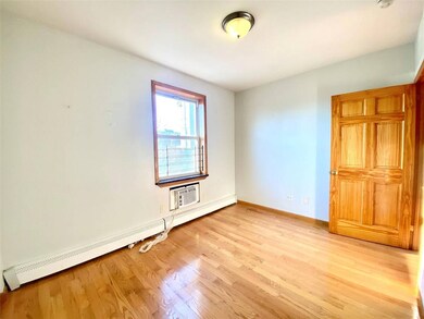 Empty room with light wood-type flooring, baseboar