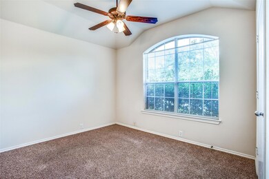 Empty room featuring ceiling fan, baseboards, lof