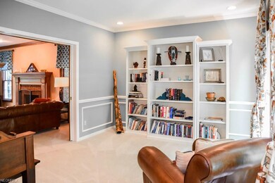 Living room with crown molding, wainscoting and re
