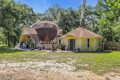 Side/Front of house featuring a patio and a shingled roof