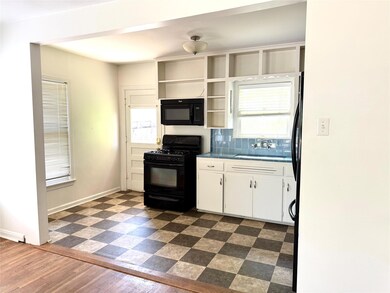 Kitchen featuring black appliances, a sink, white