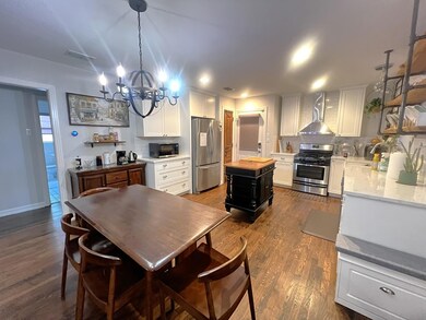 Kitchen featuring stainless steel appliances, wal