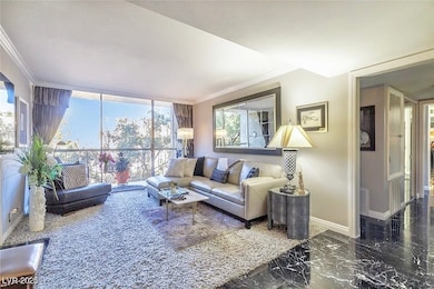 Living room featuring crown molding, baseboards, p