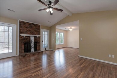 Living room with pitched ceiling and fireplace