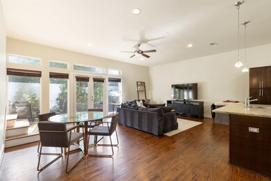 Dining room featuring recessed lighting, dark wood-style flooring, ceiling fan, French doors to second floor balcony