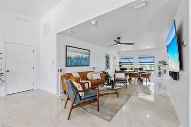 Living area featuring baseboards, marble finish fl