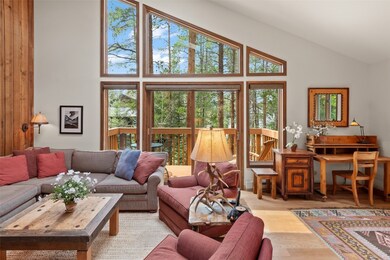Living room featuring high vaulted ceiling and lig