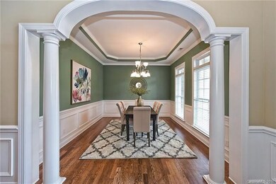 Dining room with trey ceiling and dramatic archway