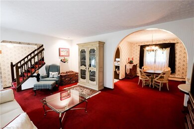 Carpeted living room featuring a textured ceiling 