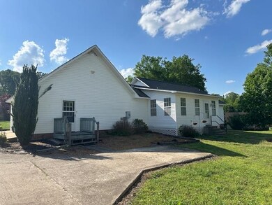 Rear view of house with a lawn