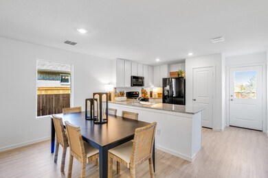 Dining area with healthy amount of natural light, light wood-style flooring, and recessed lighting