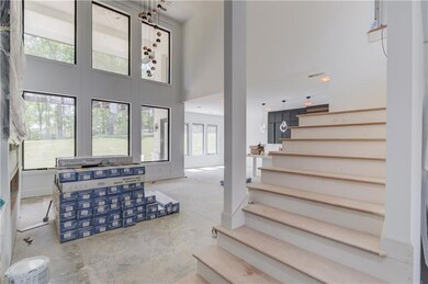 Staircase featuring concrete flooring and a high c