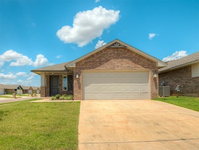 Ranch-style home featuring concrete driveway, a front lawn, a garage, brick siding, and roof with shingles