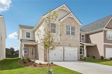 Craftsman house with brick siding, a garage, and concrete driveway