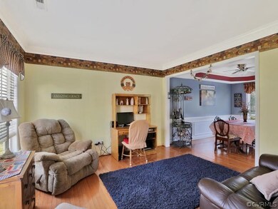 Living Room with hardwood floors and crown molding
