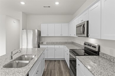 Kitchen featuring dark wood-type flooring, sink, w